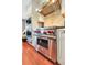 Close up of the Wolf stainless steel oven and range with a stainless hood and tile backsplash at 8 Fairway Oaks Ln, Isle of Palms, SC 29451