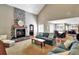 Cozy living room with a stone fireplace, comfortable seating, and lots of natural light at 8 Fairway Oaks Ln, Isle of Palms, SC 29451
