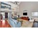 Spacious living room with vaulted ceilings, hardwood floors, and a view of the upper level at 8 Fairway Oaks Ln, Isle of Palms, SC 29451