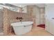 A stunning main bathroom features a soaking tub, mosaic tile shower, and custom cabinets at 8 Fairway Oaks Ln, Isle of Palms, SC 29451