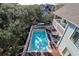 Beautiful in-ground pool surrounded by a deck, tall trees, and a white fence on this lovely property at 8 Fairway Oaks Ln, Isle of Palms, SC 29451