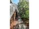 Stone walkway alongside house with privacy fence and lush surrounding greenery at 8 Fairway Oaks Ln, Isle of Palms, SC 29451