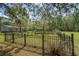 Fenced backyard with green lawn and lush trees, offering a secure area for outdoor activities and relaxation at 8072 Bing Hill Road Rd, Adams Run, SC 29426