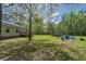 Spacious backyard with a deck, fire pit area, shed, and ample space for outdoor activities and entertaining at 8072 Bing Hill Road Rd, Adams Run, SC 29426