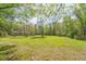 Expansive backyard featuring lush greenery and mature trees, providing a serene and private outdoor space at 8072 Bing Hill Road Rd, Adams Run, SC 29426