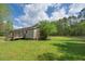Spacious backyard features a deck and well-manicured lawn, perfect for outdoor activities and relaxation at 8072 Bing Hill Road Rd, Adams Run, SC 29426