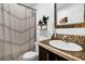 Bathroom featuring a vanity with dark cabinets, light countertops and a white toilet under floating shelves at 8072 Bing Hill Road Rd, Adams Run, SC 29426