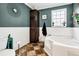 Bathroom featuring a large soaking tub, built in linen closet, and neutral flooring with white and blue walls at 8072 Bing Hill Road Rd, Adams Run, SC 29426