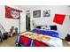 Bedroom featuring a bed covered in blankets with sports team logos and images of a horse at 8072 Bing Hill Road Rd, Adams Run, SC 29426