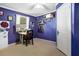 Cozy bedroom with purple walls and carpet, featuring white trim and window at 8072 Bing Hill Road Rd, Adams Run, SC 29426