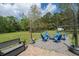 Backyard fire pit area with seating, creating a cozy and inviting space for outdoor gatherings at 8072 Bing Hill Road Rd, Adams Run, SC 29426