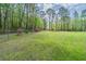 A spacious and well-maintained front yard with a charming fence and lush greenery creates a welcoming curb appeal at 8072 Bing Hill Road Rd, Adams Run, SC 29426