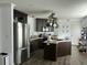 Modern kitchen featuring dark cabinetry, stainless steel appliances, and a center island at 8072 Bing Hill Road Rd, Adams Run, SC 29426