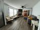 Comfortable living room featuring wood laminate floors and a brick fireplace at 8072 Bing Hill Road Rd, Adams Run, SC 29426