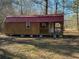 Charming outbuilding with a red roof, ideal for a workshop, studio, or additional storage at 8072 Bing Hill Road Rd, Adams Run, SC 29426