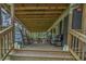 Inviting front porch with rocking chairs and seating, perfect for relaxing and enjoying the outdoors at 8072 Bing Hill Road Rd, Adams Run, SC 29426
