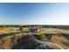 Stunning aerial view of the clubhouse overlooking the manicured green lawns of the scenic golf course at 821 Bulls Bay Blvd, Mount Pleasant, SC 29429
