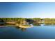 Aerial view showcases a home with a scenic green island in the middle of a still lake surrounded by trees at 821 Bulls Bay Blvd, Mount Pleasant, SC 29429
