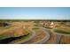 Aerial view of a golf course and clubhouse with winding cart paths, manicured greens, and water features at 821 Bulls Bay Blvd, Mount Pleasant, SC 29429