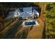 Aerial view showcases a home with a pool, patio, and a sprawling green lawn surrounded by lush trees at 821 Bulls Bay Blvd, Mount Pleasant, SC 29429