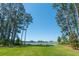 Expansive backyard featuring lush greenery and a scenic view of a tranquil lake framed by tall trees at 821 Bulls Bay Blvd, Mount Pleasant, SC 29429