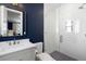 Stylish bathroom features navy blue walls, white vanity, and a tiled glass-enclosed shower at 821 Bulls Bay Blvd, Mount Pleasant, SC 29429