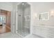 Bathroom featuring a glass shower, vanity with sconces and a lighted mirror at 821 Bulls Bay Blvd, Mount Pleasant, SC 29429