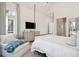 Bedroom with sitting area, four-poster bed, and a view of the outdoor landscape at 821 Bulls Bay Blvd, Mount Pleasant, SC 29429