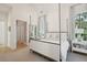 Bedroom with four-poster bed, bedside table, and adjacent hallway at 821 Bulls Bay Blvd, Mount Pleasant, SC 29429