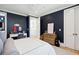 Stylish bedroom with golf-themed decor, navy walls, and natural light at 821 Bulls Bay Blvd, Mount Pleasant, SC 29429