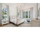 Bright bedroom with a four-poster bed, chandelier, and natural light at 821 Bulls Bay Blvd, Mount Pleasant, SC 29429