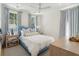 Bright bedroom with a blue-trimmed bed, striped curtains, and natural light from two windows at 821 Bulls Bay Blvd, Mount Pleasant, SC 29429