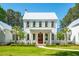 Charming two-story home featuring a pristine lawn, manicured landscaping, and symmetrical facade at 821 Bulls Bay Blvd, Mount Pleasant, SC 29429