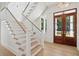 Bright foyer with hardwood floors, elegant staircase, and a beautiful wooden front door at 821 Bulls Bay Blvd, Mount Pleasant, SC 29429