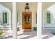 Inviting front porch with brick flooring, white columns, and wooden double doors at 821 Bulls Bay Blvd, Mount Pleasant, SC 29429