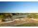 Picturesque golf course showcasing lush green lawns, a tranquil lake, and mature trees under a clear blue sky at 821 Bulls Bay Blvd, Mount Pleasant, SC 29429
