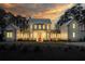 Elegant home exterior with warm lighting, showcasing a charming facade and inviting curb appeal at twilight at 821 Bulls Bay Blvd, Mount Pleasant, SC 29429