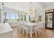 Chef's kitchen with large island, white cabinetry, and stunning backyard lake view at 821 Bulls Bay Blvd, Mount Pleasant, SC 29429