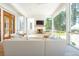 Well-lit screened living room with a white brick fireplace and outdoor views at 821 Bulls Bay Blvd, Mount Pleasant, SC 29429