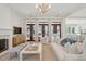 Bright living room with hardwood floors, glass doors, fireplace, and modern decor at 821 Bulls Bay Blvd, Mount Pleasant, SC 29429