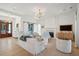 Bright living room with fireplace, white trim, light hardwood floors and comfortable seating at 821 Bulls Bay Blvd, Mount Pleasant, SC 29429
