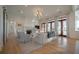 Spacious living room featuring a fireplace, hardwood floors, and ample natural light from doors at 821 Bulls Bay Blvd, Mount Pleasant, SC 29429