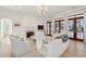 Bright and airy living room featuring hardwood floors, a fireplace, and glass doors to the outside at 821 Bulls Bay Blvd, Mount Pleasant, SC 29429