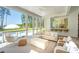 Well-lit screened living room featuring an outdoor kitchen and views of the pool at 821 Bulls Bay Blvd, Mount Pleasant, SC 29429