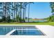 Modern zero-edge pool and spa overlooking a lush green golf course, a serene lake, and an elegant clubhouse at 821 Bulls Bay Blvd, Mount Pleasant, SC 29429