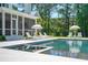 Beautiful pool with lounge chairs and umbrellas surrounded by a spacious green lawn at 821 Bulls Bay Blvd, Mount Pleasant, SC 29429