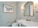 Stylish powder room featuring patterned wallpaper, gold fixtures, and a white sink at 821 Bulls Bay Blvd, Mount Pleasant, SC 29429