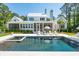 Beautiful pool with spa and lounge area behind large modern farmhouse with a metal roof at 821 Bulls Bay Blvd, Mount Pleasant, SC 29429