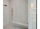 Close-up of the marble tiled shower with a built-in bench and glass door enclosure at 821 Bulls Bay Blvd, Mount Pleasant, SC 29429