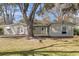 Residential home exterior featuring a spacious yard with mature trees and a grill at 834 Prince John Dr, Charleston, SC 29407